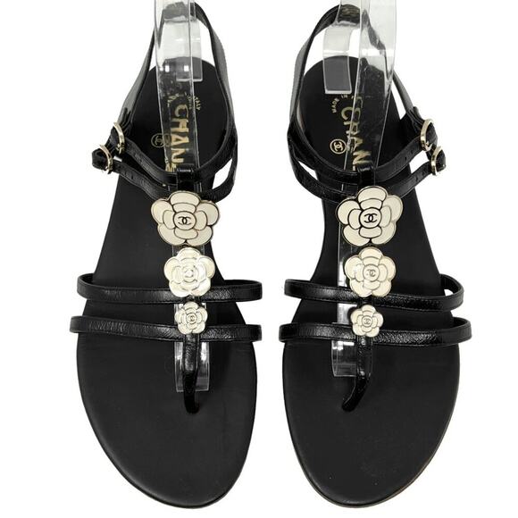 CHANEL Shoes - Chanel Black Leather Gladiator Strappy Enamel Flower Logo Flat Sandals